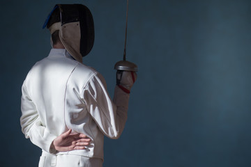 the fencer prepares for competitions. fencing coach. fencing sport motivation. mask and sword - obrazy, fototapety, plakaty