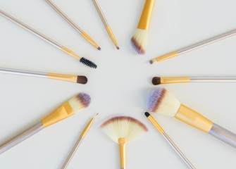 Set of make up silver and gold brushes on white background