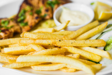 grilled meat with french fries close up