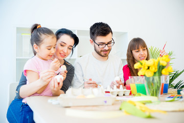 Family painting eggs