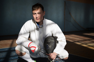 the fencer prepares for competitions. fencing coach. fencing sport motivation. mask and sword