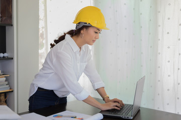 Asian women engineering using notebook for working at office