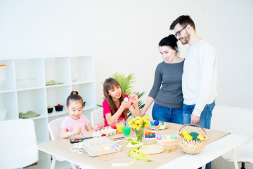 Family painting eggs