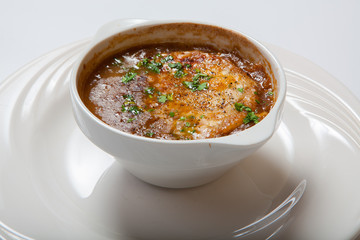 French onion soup in a deep white bowl.