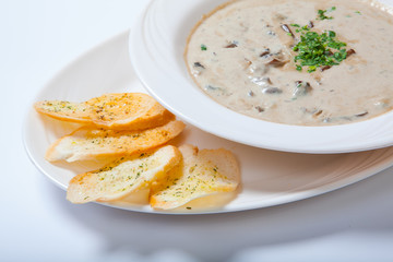 Mushroom cream soup with croutons, herbs and spices