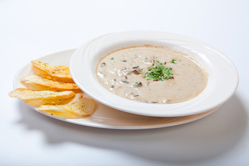 Mushroom cream soup with croutons, herbs and spices
