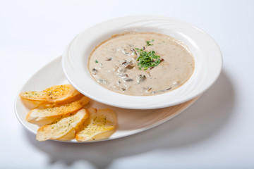Mushroom cream soup with croutons, herbs and spices