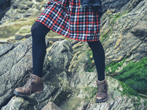 Legs of woman standing on rocks