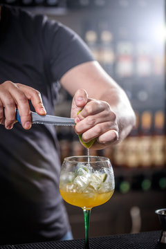Bartender muddling lime