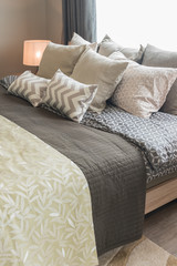 set of pillows on bed in cozy bedroom