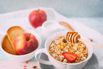 Oat flakes in bowl and wooden spoon