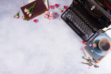 Workspace scene with vintage typewriter, coffee cup and books