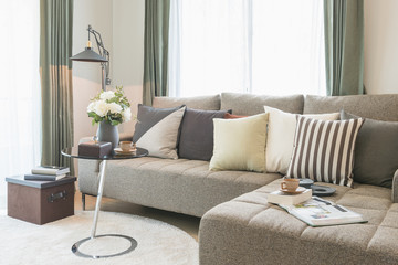 vase of flower on round glass table with set of sofa in modern living room