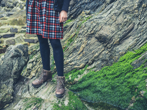 Legs of woman standing on rocks