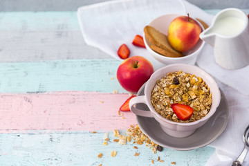 Granola bowl with milk and apples. Healthy breakfast