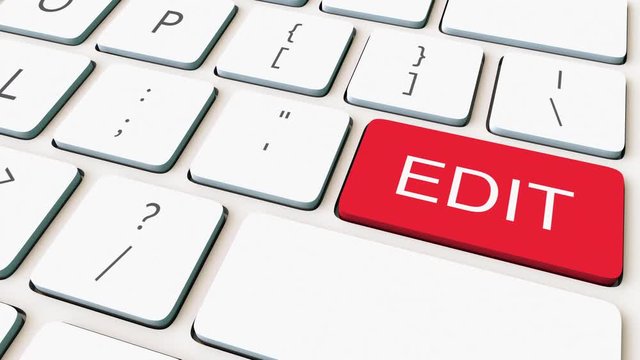 Close-up dolly shot of white computer keyboard and red edit key. Conceptual 4K clip