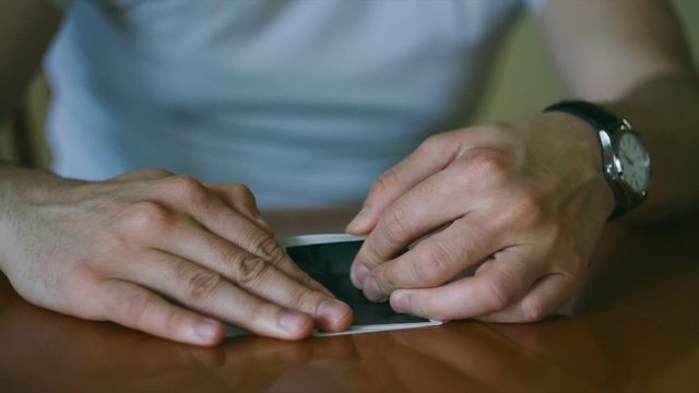 Player folding poker cards slow motion