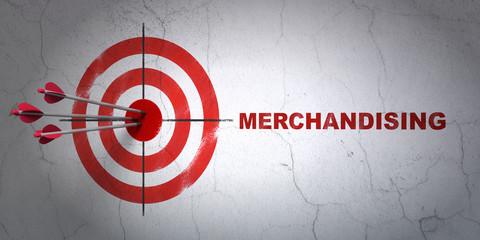 Marketing concept: target and Merchandising on wall background