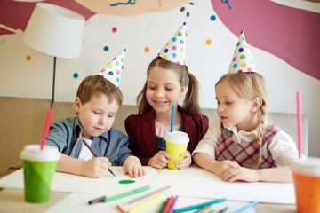 Fototapeta premium Creative kids drawing pictures with crayons and highlighters