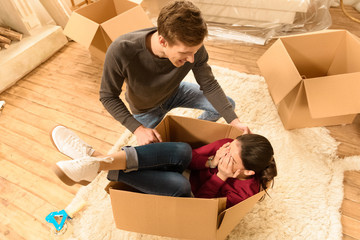 high angle view of woman and man having fun at new home