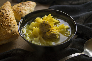 Meatball soup with bread on the table in natural light