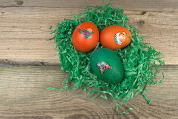Colorful Easter eggs on old wooden table