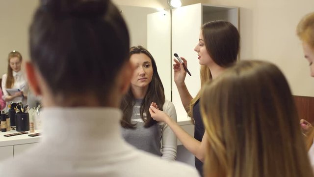 Make-up artist conducts training lesson on the technique of makeup.