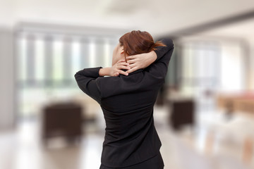 Businesswoman neck pain while standing at office - office syndrome concept.