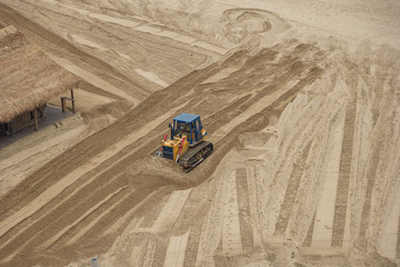 bulldozer flattens beach sand. top view