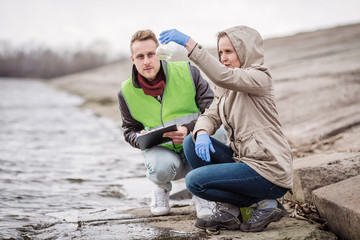 Scientists or biologists working together on water analysis. .