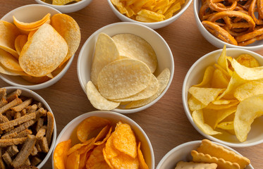 Pretzels in bowls on wooden table from above