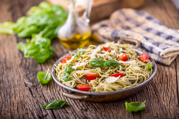 Spaghetti. Italian pasta spaghetti with basil pesto cherry tomatoes and olive oil.