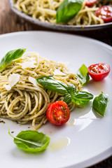 Spaghetti. Italian pasta spaghetti with basil pesto cherry tomatoes and olive oil.