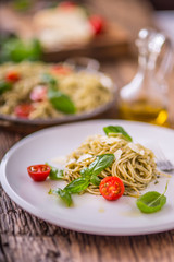 Spaghetti. Italian pasta spaghetti with basil pesto cherry tomatoes and olive oil.