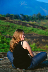 Obraz premium Young girl on top of a mountain.