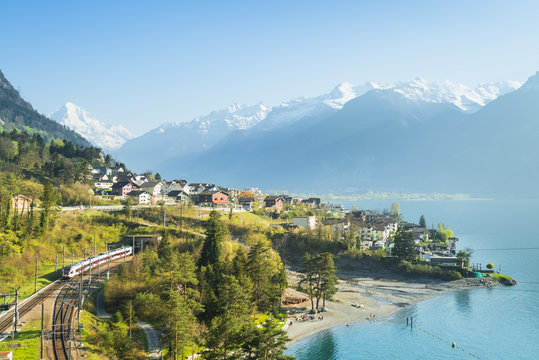 Small towns in Europe. Fluelen. Switzerland. View of the small town in the Alps mountains. Traditional houses. Railway along Lake Lucerne. Canton of Uri.