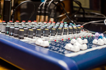 Blue DJ audio mixer shot close-up
