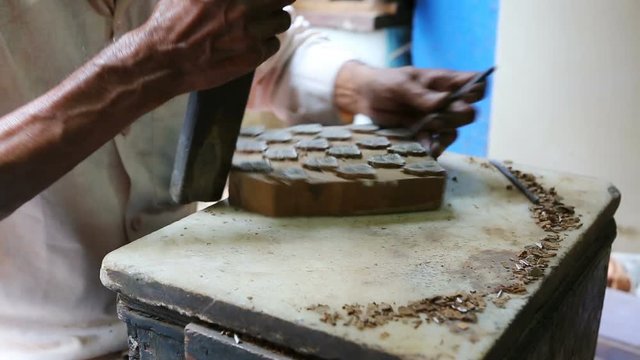 Craftsman making a wooden block for Block Printing for Textile in India. Mumbai, Maharashtra, India.
