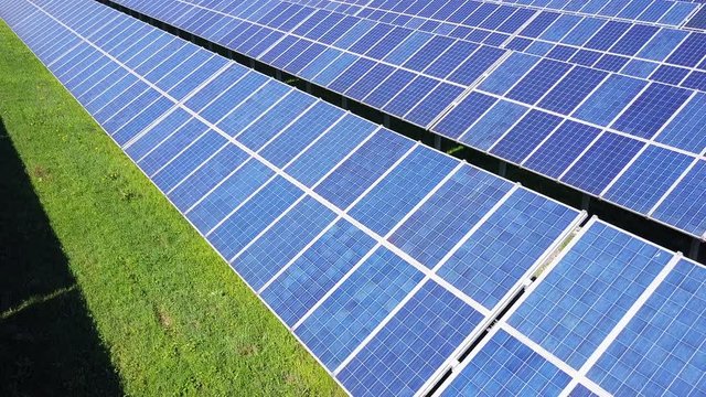alternative energy solar panels farm aerial view flying close