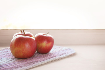 Fresh apples on windowsill