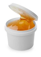 Plastic bucket with sugaring paste on white background
