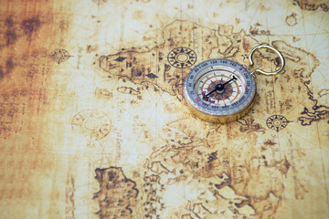 Vintage compass on world map,  exploring on earth background concept.