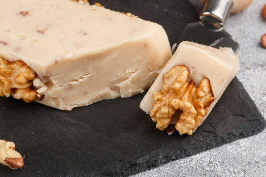 Gourmet cheese with walnuts. Processed. Selective focus