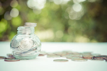 Coins in glass jar for money saving for housing,financial concept