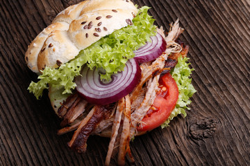 Pulled pork burger with coleslaw tomato, onion and fresh bread.