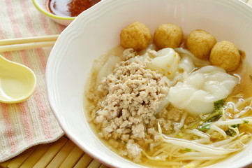 rice noodles topping boiled minced pork and shrimp ball in soup with chili sauce