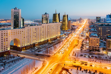View from above on a large avenue that goes to the horizon, a golden skyscraper and a house of ministries in Astana, Kazakhstan
