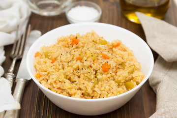 couscous with vegetables in white bowl