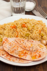 grilled chicken breast with couscous on white dish