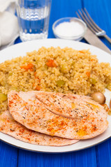 grilled chicken breast with couscous on white dish